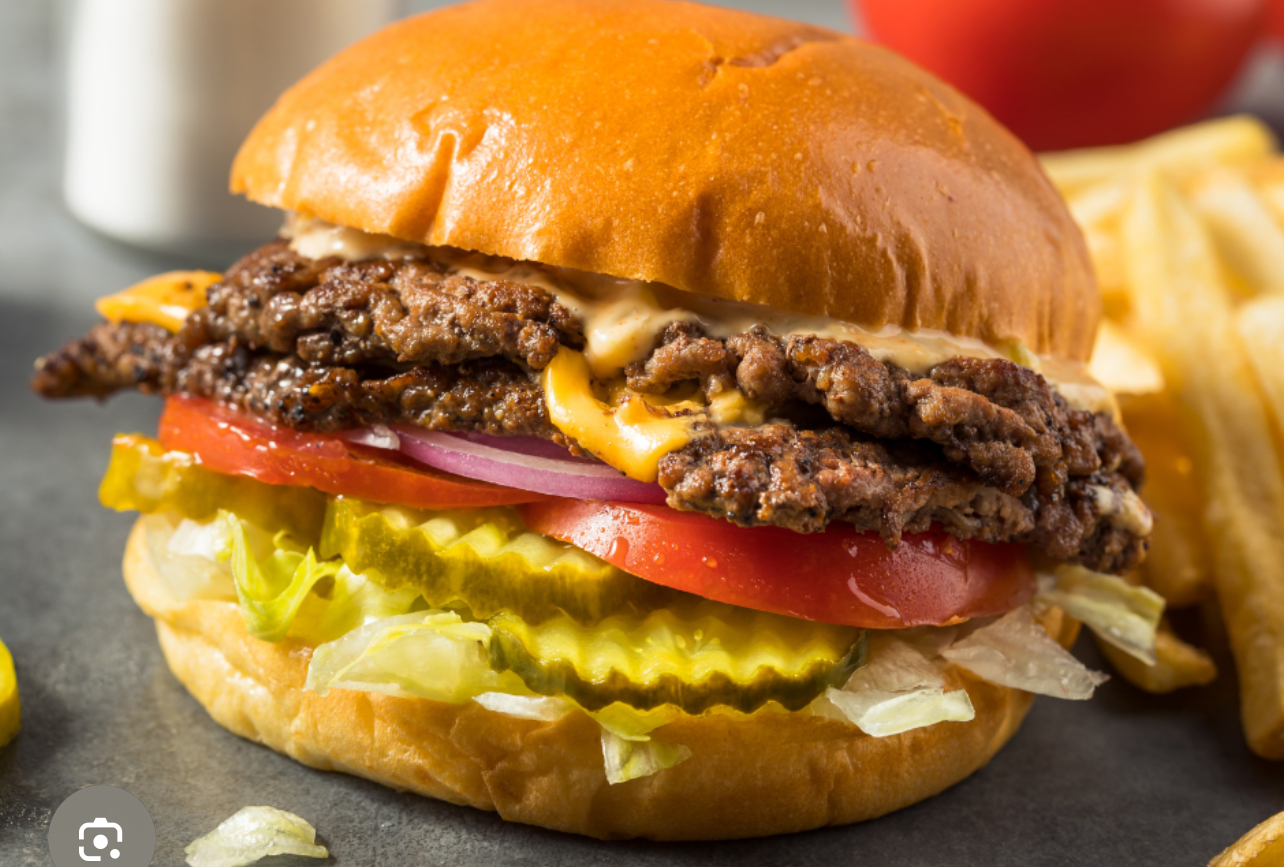 Mallie's Burgers double smashburger with pickles, lettuce and tomato beside hand-cut fries